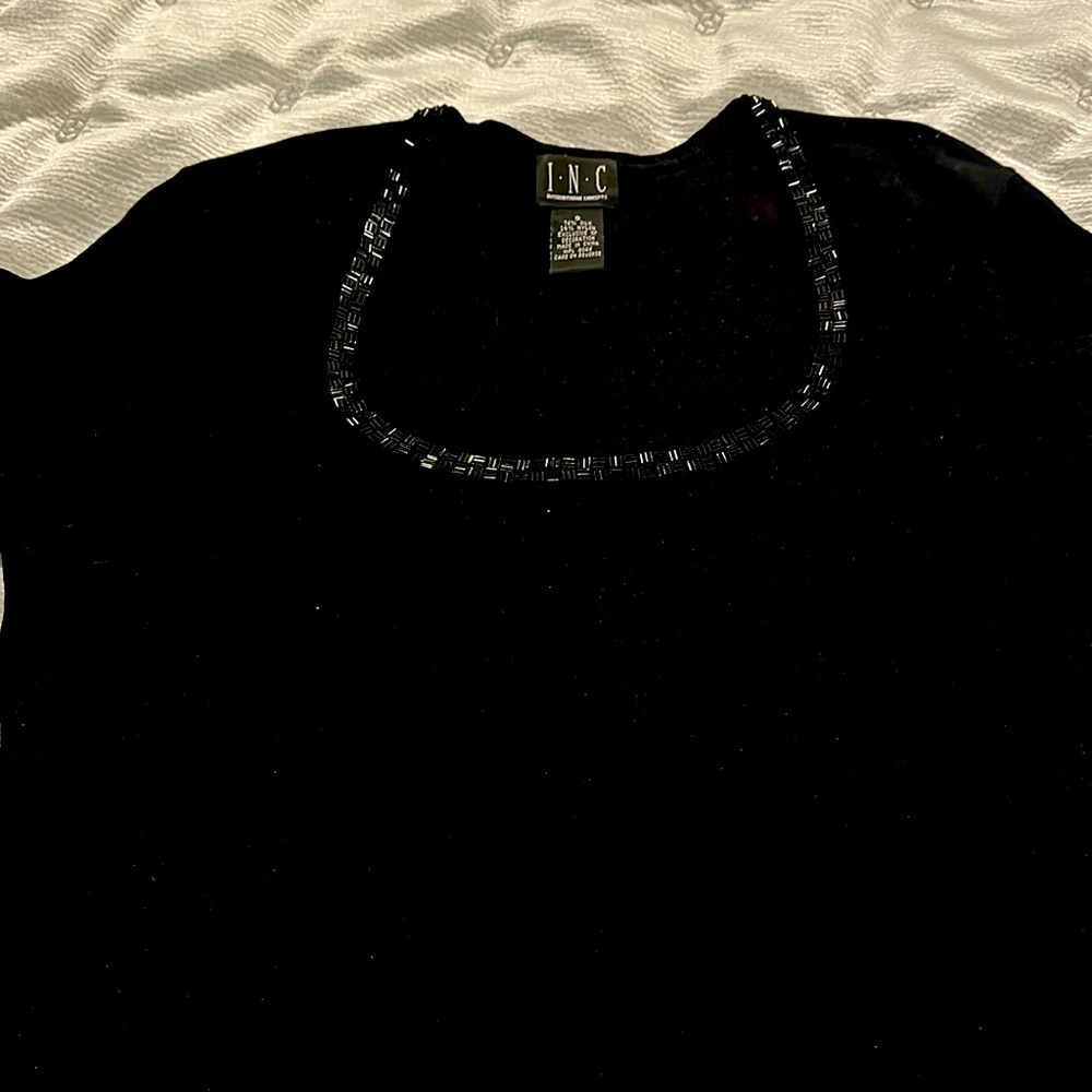 INC black long sleeve sweater w/black beaded neckline 76% Silk 24% nylon. SMALL